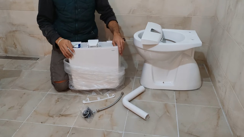 Majstor vrši vizuelnu inspekciju svih delova pre montaže wc šolje i vodokotlića