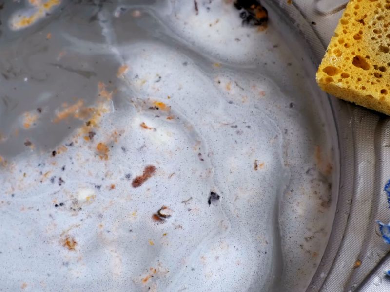 prikaz zapušene sudopere sa ostacima hrane i vodom